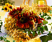 Wicker basket with oats, Helianthus annuus, basket with foil lining