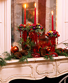 Candles decorated for Christmas on the mantelpiece