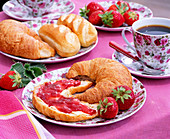 Fragaria strawberries, croissant with strawberry jam, tableware with roses motif