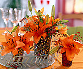 Lilium 'Tresor' (lilies, pink) rosehips in mosaic vases