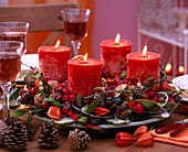 Advent wreath with cones, branches and red candles