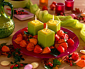 Glass plate with green candles, Physalis (lampions), Hedera (ivy), Rosa (rosehip)