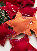 Christmas tree decorations, stars sewn of felt, red and orange