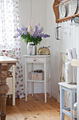 Vase of lupins on small table in kitchen