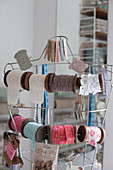 Reels of vintage-style trims and ribbons hung from tailors' dummy