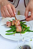 Scallops wrapped in ham and served with green beans