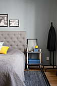 Bedside table on castors in bedroom in shades of grey