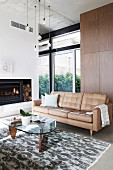 Beige leather room and retro coffee table in the living room with fireplace