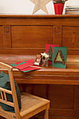 Christmas card with crocheted fir tree on front on piano lid