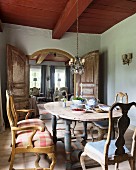 Wooden table, 18th-century Swedish chairs and double doors