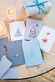 Embroidered Christmas cards on a wooden table