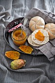 Homemade vegan prickly pear jam with crusty bread roll halves