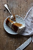 A slice of moist orange cake with a ginger and cream cheese frosting