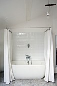 White bathtub with shower curtain in renovated period building