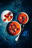 Tomato and red onionsoup, fresh rosemary leafs