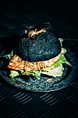 Halloween Chicken burger with Mealworms and topped with a giant Waterbug