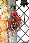 Bouquet of viburnum berries, rose hips, reeds and raspberry leaves