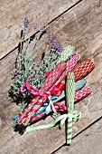 Hand-made lavender wands and lavender on wooden surface