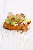 A crostini with truffle and celery