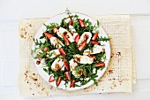 Cashew and mozzarella salad with rocket and strawberries