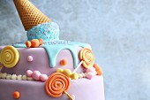 Brightly coloured fondant 'Candy Cake' decorated with lollies and melting ice cream from a cone