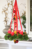 Classic Advent wreath hung from red ribbons