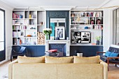 Fireplace and mirror between fitted shelves