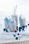 Blueberry milkshakes in glass bottles