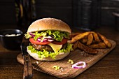 Cheeseburger with tomatoes, onion and lettuce