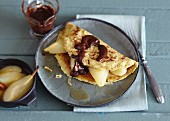 Nut pancakes with pear and chocolate sauce