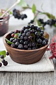 Aronia berries in a wooden bowl