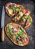 Naan bread pizza with prosciutto and rocket