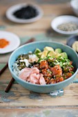 Salmon poke with avocado, spring onions and rice