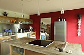 Island counter and red wall in kitchen