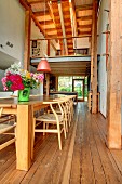 Colourful vase of flowers in dining area in front of gallery