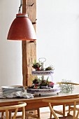 Festive Easter flower arrangement on cake stand on wooden table