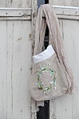 Hand-sewn fabric bag with embroidered snowdrops