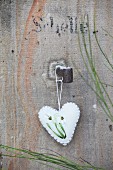 White boiled-wool heart embroidered with snowdrops