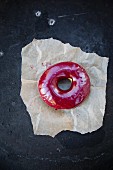 Blueberry donut on paper (top view)