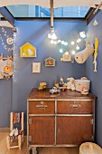 Workshop cabinet in nursery with blue walls and skylight