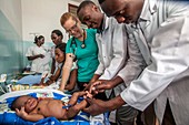 Hospital doctors examining babies