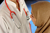 Doctor and muslim woman patient