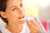 Woman bleaching teeth