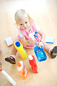 Baby playing with cleaning products