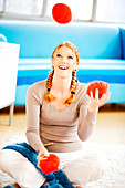 Woman juggling with balls of wool