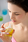 Woman smelling perfumed oil