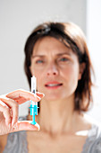 Woman injecting herself heparin