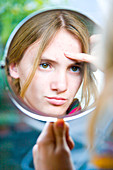 Teenager girl at mirror