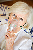 Elderly woman with oxygen mask