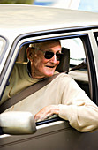Elderly man driving a car